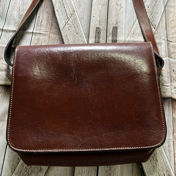 brown leather and features the gold-toned horsebit hardware.  B36 - Picture 9 of 9